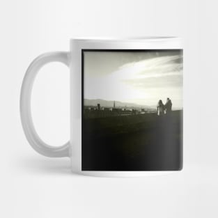 A couple take in the view near Edinburgh Castle Mug